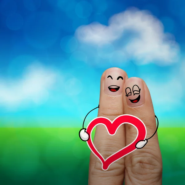 O casal dedo feliz no amor com smiley pintado e segure hea — Fotografia de Stock