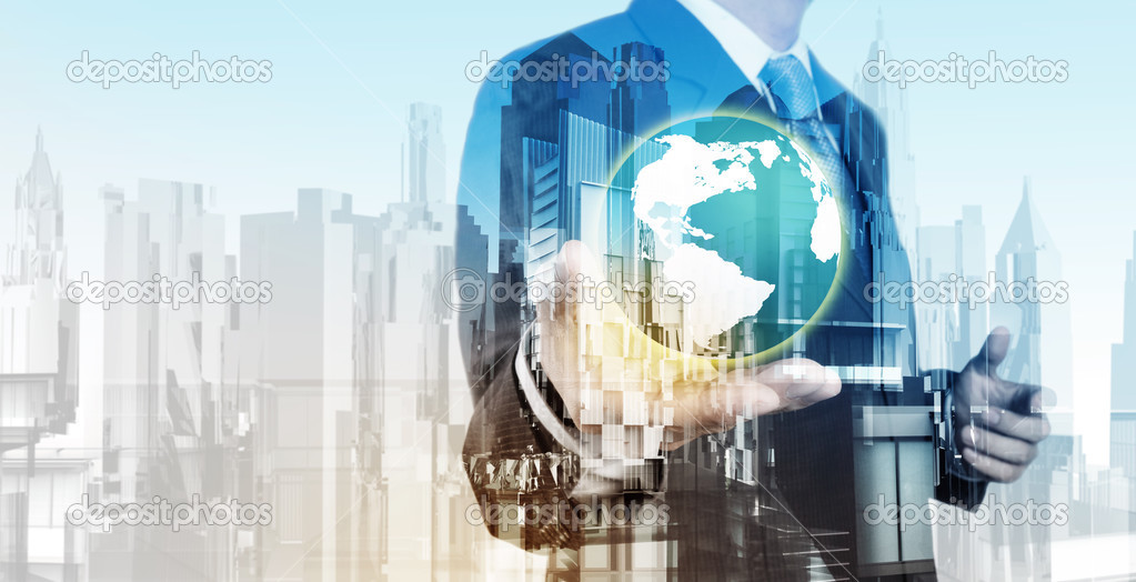 Double exposure of business engineer holding the earth and abstr