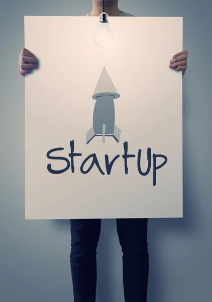 Businessman hand showing poster of start up icon as concept — Stock Photo, Image