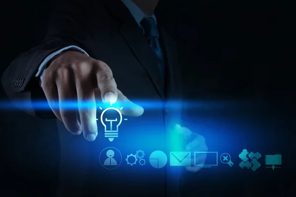 Businessman hand draws lightbulb with new computer interface as — Stock Photo, Image