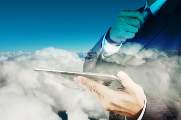 Double exposure of businessman hand using digital tablet with cl — Stock Photo, Image