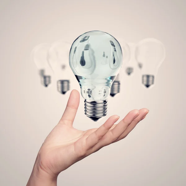 Hand showing 3d light bulb as vintage concept — Stock Photo, Image