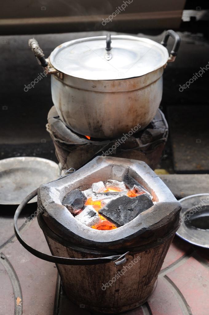 Charcoalbrazier fired and cooking pot. Stock Photo by ©ekarina 34507593