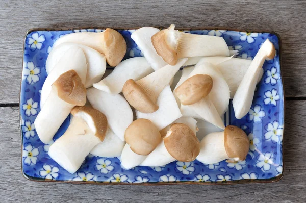 Mushrooms sliced in blue plate — Stock Photo, Image
