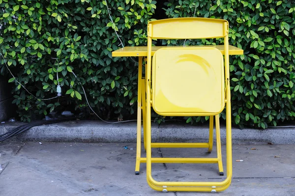 Yellow steel table sets with folding chairs. — Stock Photo, Image