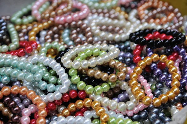 Many color bracelets in market fair, artificially — Stock Photo, Image