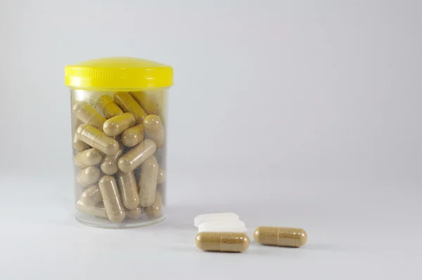 Capsules in plastic fles — Stockfoto