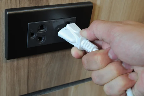Man hand plug connector into socket — Stock Photo, Image