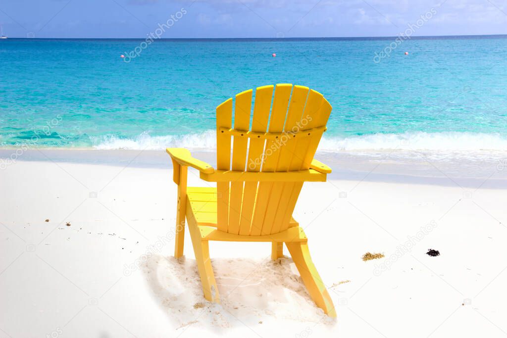 Yellow chair on a white sand beach