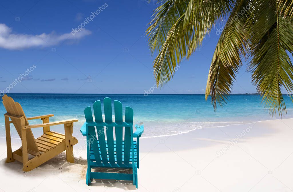 Two chairs on white sand Caribbean beach