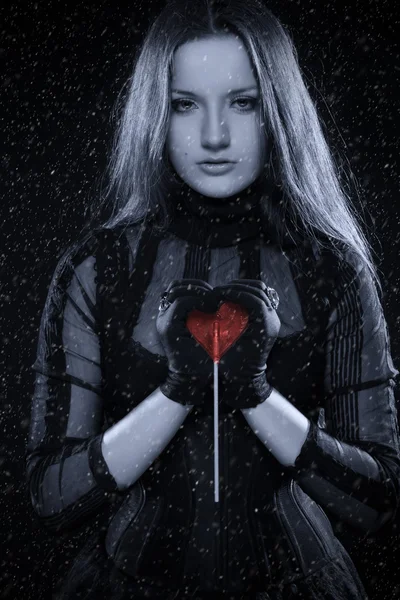 Cold gothic girl with red heart in her hands — Stock Photo, Image