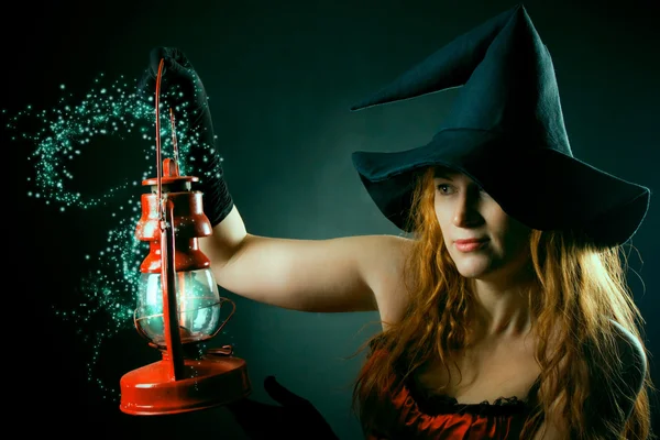 Witch with the magic lantern — Stock Photo, Image