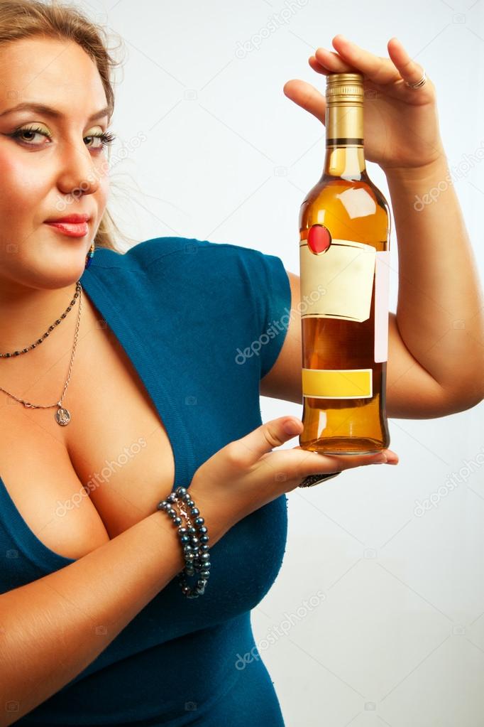 Sexy young woman with bottle of rum