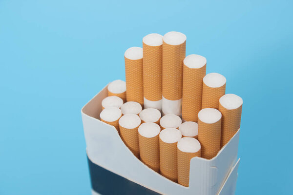 Closeup shot of cigarette pack over blue background