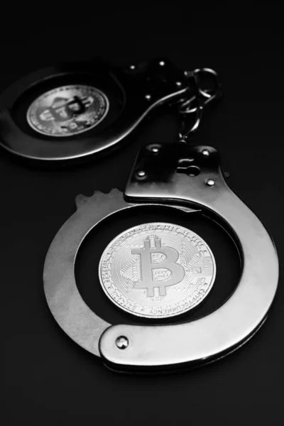 Bitcoins Und Handschellen Vor Grauem Hintergrund lizenzfreie Stockfotos