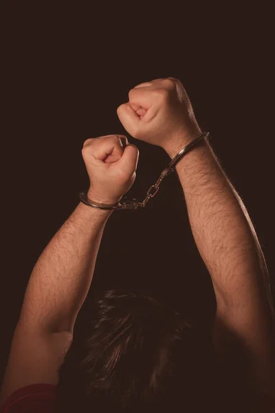 Männliche Hände Handschellen Vor Dunklem Hintergrund Stockfoto