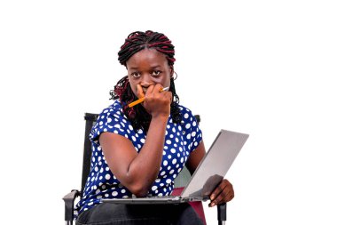 Güzel genç iş kadını bir sandalyede oturmuş laptopla çalışırken düşünüyor..