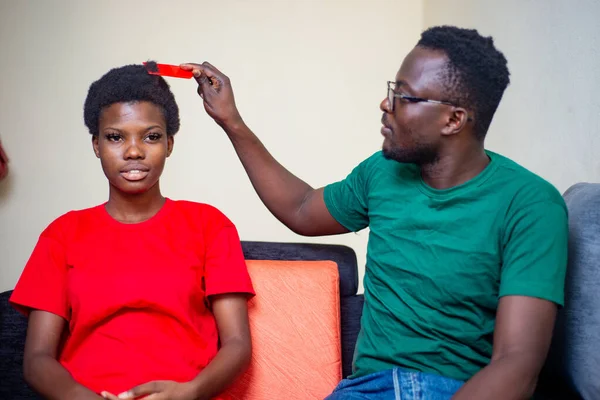 Young African Couple Sitting Together Sofa Home Man Combing Hair — Stock Photo, Image