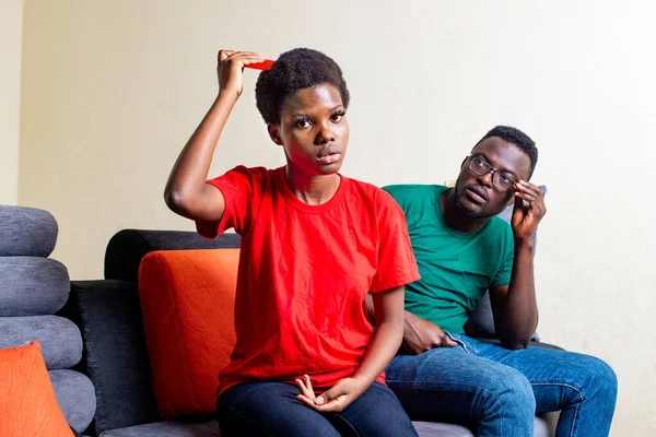 Young African Couple Sitting Together Sofa Home Man Watching His — Stock Photo, Image