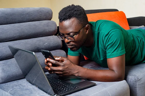 Young Man Wearing Optical Glasses Lying Sofa Home Uses Mobile — Stock Photo, Image