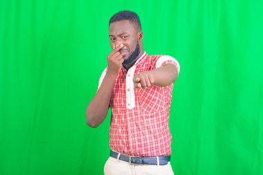 Kötü bir koku yüzünden nefesini tutan yakışıklı bir gencin portresi..