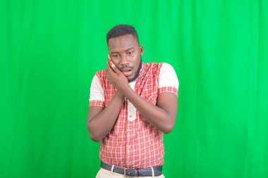 Diş ağrısından muzdarip, el ele tutuşan yakışıklı bir gencin portresi..