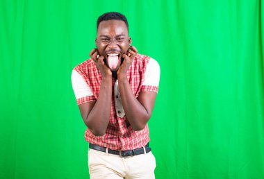 Yakışıklı bir gencin portresi. Yüzüyle komik suratlar yapıyor..