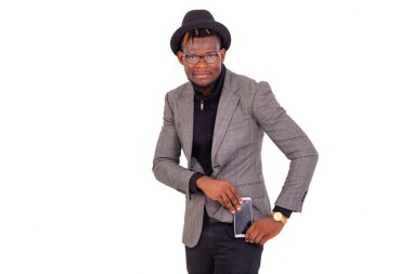 Zarif bir takım elbise giyen yakışıklı genç işadamı pantolonunun cebine bir cep telefonu koyar ya da alır..