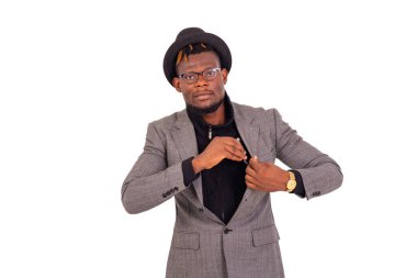 Zarif bir takım elbise giyen yakışıklı genç işadamı ceketinin cebine bir cep telefonu koyar ya da alır..