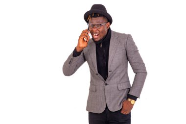 Zarif takım elbiseli yakışıklı bir iş adamı cep telefonuyla konuşuyor..