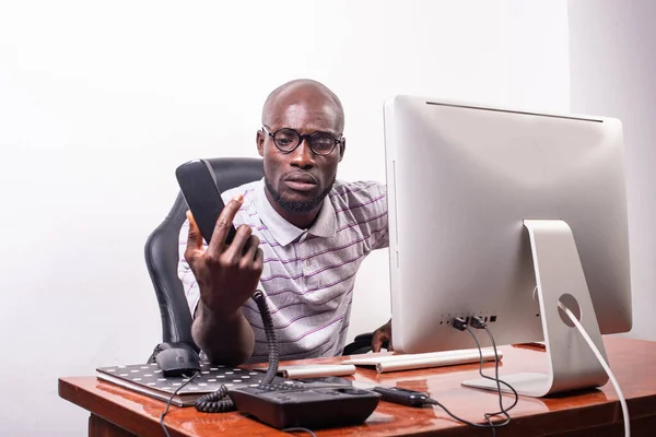 Joven Hombre Negocios Sentado Escritorio Frente Computadora Portátil Sosteniendo Teléfono —  Fotos de Stock