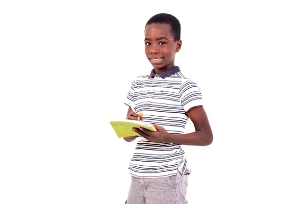 Jonge Jongen Shirt Staan Witte Achtergrond Schrijven Een Notebook Glimlachen — Stockfoto