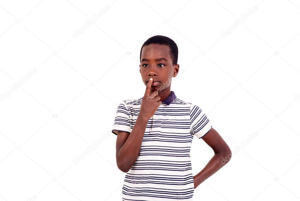 Teenage girl standing thinking focused on doubt with finger over mouth wondering