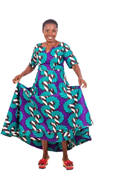 African Woman Standing White Background Showing Her Dress While Smiling Stock Photo