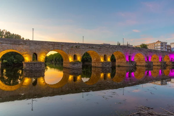 Sunset view of roman bridge over river Guadiana leading to Alcazaba fortress in Merida, Spain