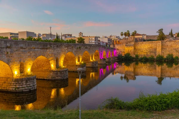 Sunset view of roman bridge over river Guadiana leading to Alcazaba fortress in Merida, Spain