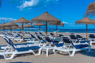 Marbella, İspanya 'daki Playa de Venüs' te güneşlik ve şemsiyeler.