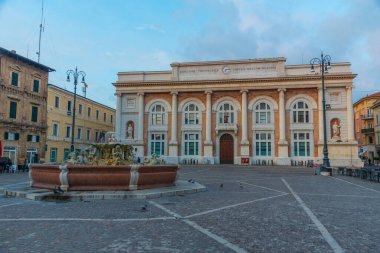 Pesaro, İtalya 'da Postane sarayı ve Neptün çeşmesiyle Piazza del Popolo' nun gündoğumu manzarası.