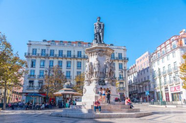 Lisbon, Portugal, October 24, 2021: People are passing through Luis de Camoes square in Lisbon, Portugal.. clipart