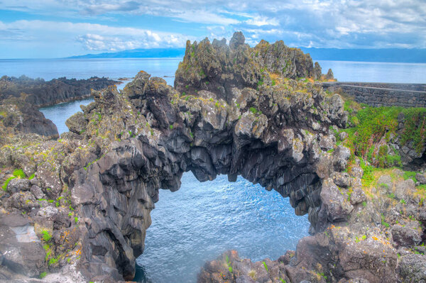 Rock arch at Velas town at Sao Jorge island at the Azores, Portugal.