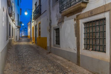 Portekiz 'in Evora kasabasındaki dar bir caddenin gece görüşü.