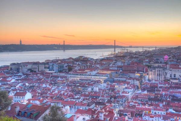 25 Nisan Köprüsü 'nün gün batımı manzarası ve Lizbon, Portekiz' deki Cristo Rei Ulusal Sığınağı.