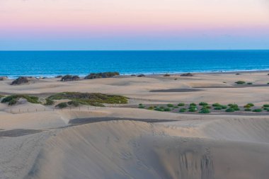 Maspalomas, Gran Kanarya, Kanarya Adaları, İspanya 'da kum tepeleri üzerinde gün batımı.