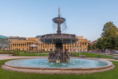 Almanya 'nın Stuttgart kentindeki Schlossplatz' da bir çeşmenin gün doğumu manzarası