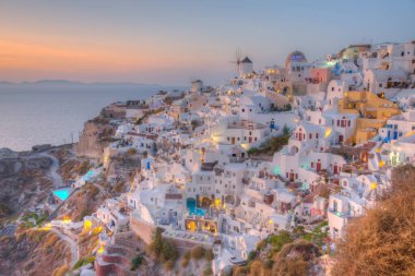 Yunanistan 'ın Santorini adasındaki Oia köyü üzerinde gün batımı