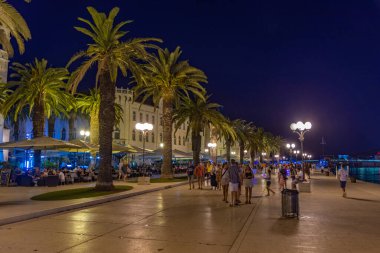 Trogir, Hırvatistan, 22 Temmuz 2020: Hırvatistan 'ın Trogir kentinde insanlar gece boyunca deniz kenarında gezinti yapıyorlar