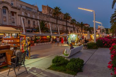 Split, Hırvatistan, 29 Temmuz 2020: Hırvatistan 'ın Split kentinde deniz kenarında yürüyen insanların gece görüşü
