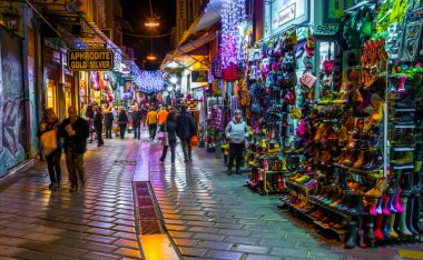 ATHENS, GREEC, DECEMBER 10, 2015: Night view of a shopping street near monastiraki square - one of the most important tourist street in the historical district of athens called plaka
