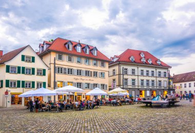 KONSTANZ, GERMANY, 23 Temmuz 2016: Almanya 'daki Konstanz katedralinin önündeki meydanda insanlar akşam yemeğinin tadını çıkarıyor
