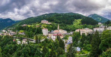 BAD GASTEIN, AUSTRIA, JULY 29, 2016: Austrian ski and spa resort Bad Gastein dominated by a parish church and a waterwall flowing through ist city center.